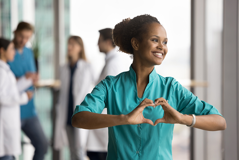 lady making the heart symbol with her hands