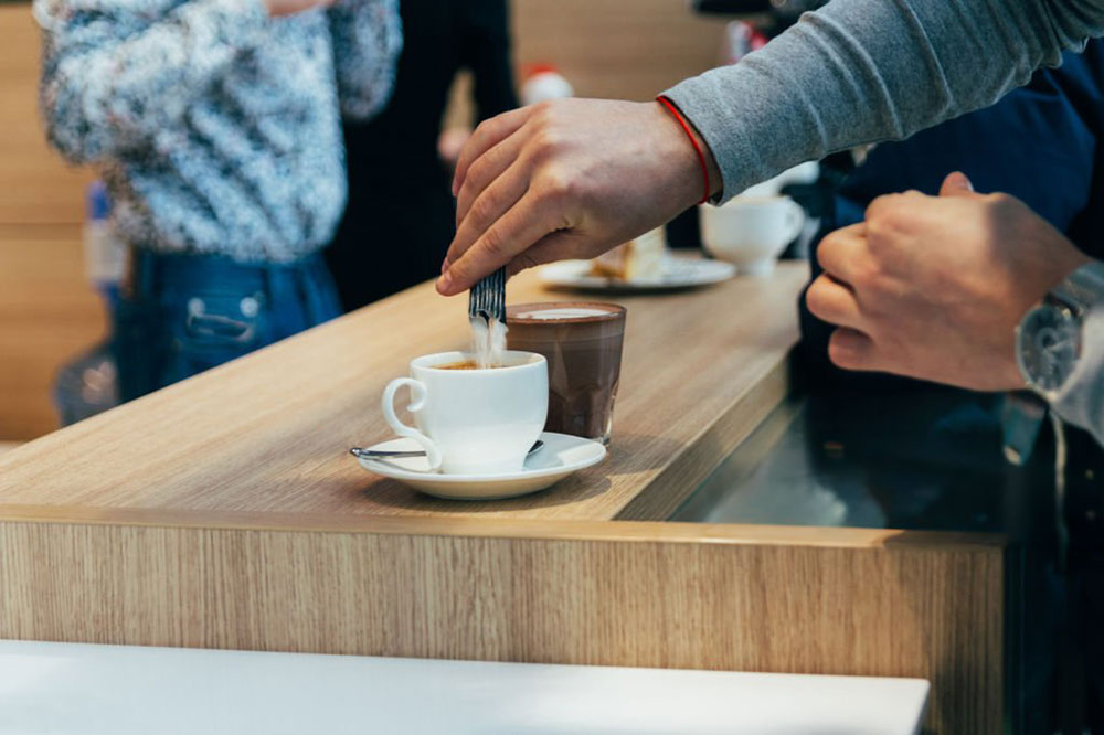 stick pack pouring into coffee cup