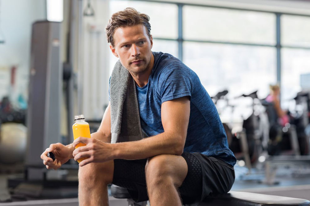 Guy working out and drinking a functional beverage