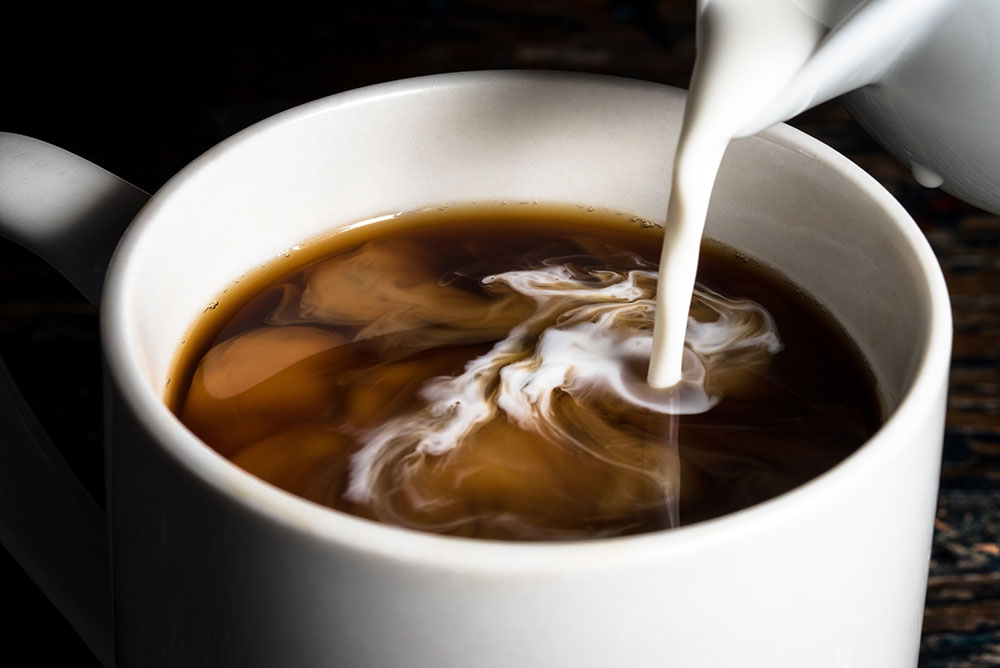 creamer pouring into coffee