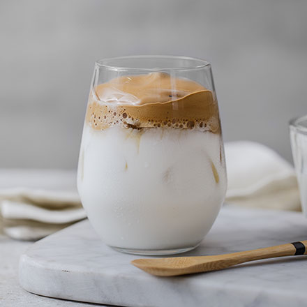 A glass of milk with some ice cream in it